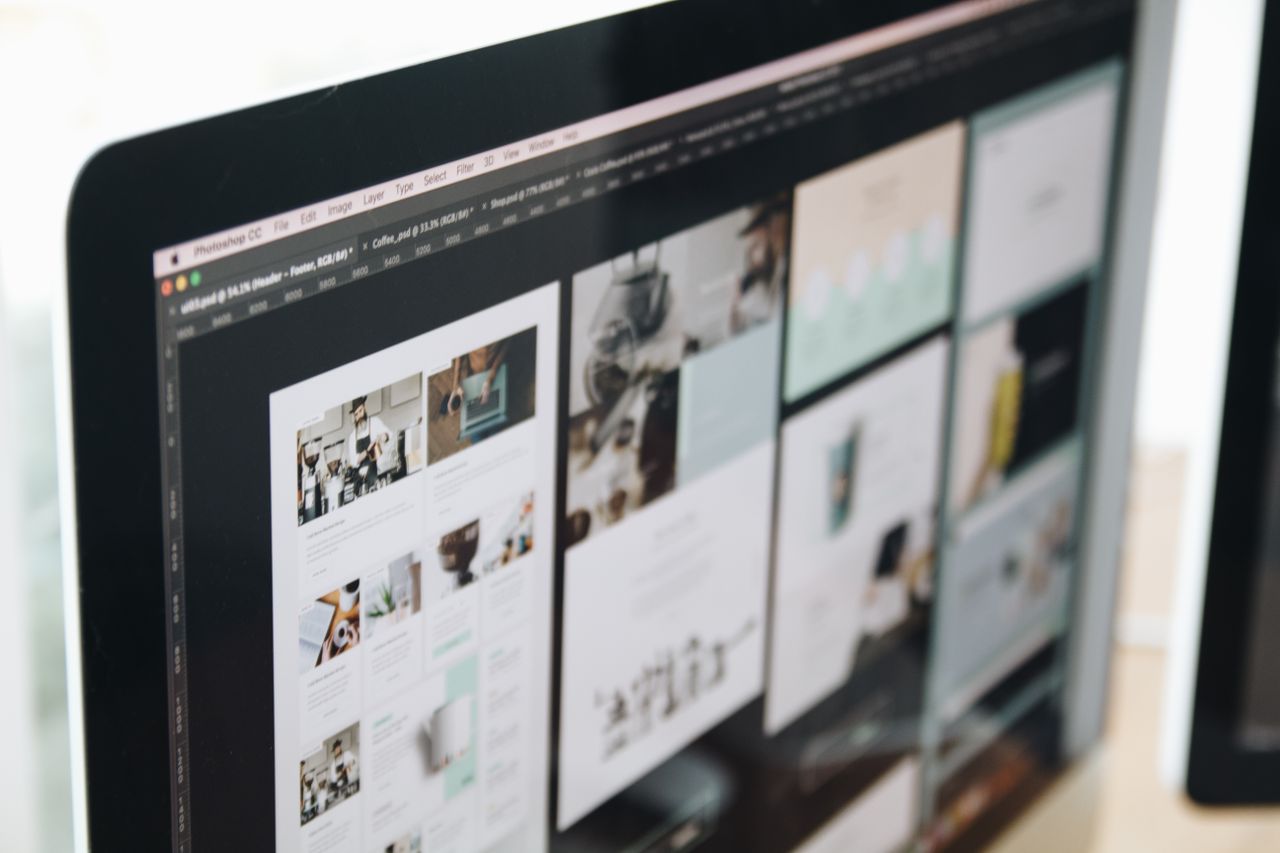 Un écran d’ordinateur moderne affichant un travail de web design, mettant en valeur des visuels créatifs dans un espace de travail.